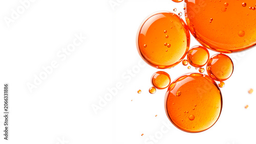 Foto Liquid golden orange cosmetic oil or serum bubbles macro texture isolated on tra