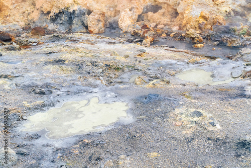 geothermal activity colors the earth and water in the geothermal area of Seltun in Reykjanes Peninsula in Iceland on a march day