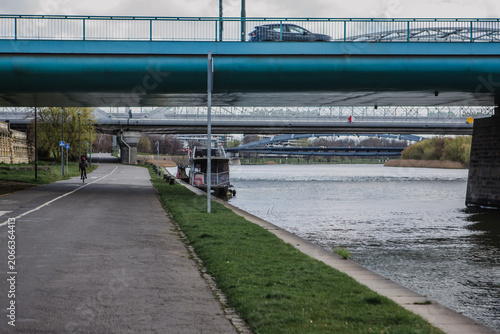Bild auf Leinwand Photos of a blue bridge over the Wisla River in Krakow, Poland on a Winter after