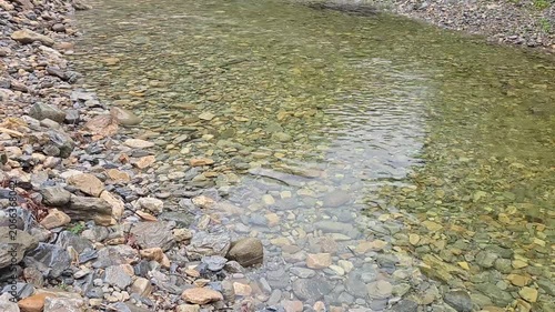 Crystal clear mountain stream flowing through rocky valley surrounded by lush green forest in Jeongseon Gangwon South Korea