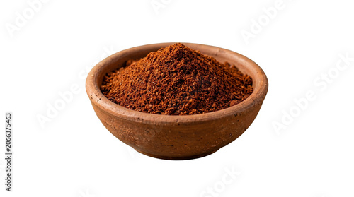 Fine red chili powder in a small clay bowl with seasoning culinary aromatic ingredient flavoring