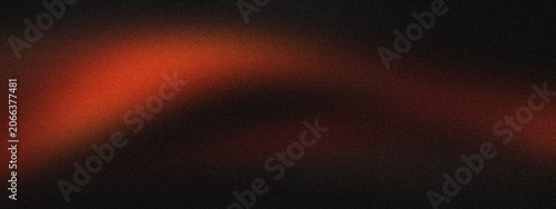orange light band with soft focus and grainy texture on a dark black background.