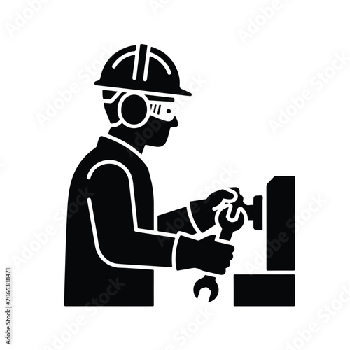 Industrial professional wearing safety gear repairing machinery with wrench tool