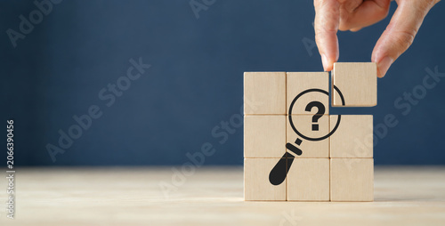 Problems and root cause analysis concept. Define problems to find solution. The wooden cubes with illustration magnifying glass to analyze question mark sign on grey background and copy space.
