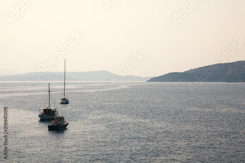 Peace and quiet. Yachts at sea in the morning fog.