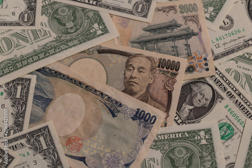 Mixed Japanese yen and US dollar banknotes background flat lay