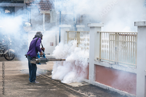 Workers are spraying insecticide to kill mosquitoes in the community