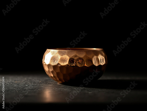 Hammered copper bowl with textured surface, metallic sheen, warm copper color, studio lighting, shallow depth of field
