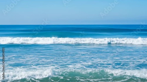 Beautiful blue ocean waves crashing on a sunny tropical beach