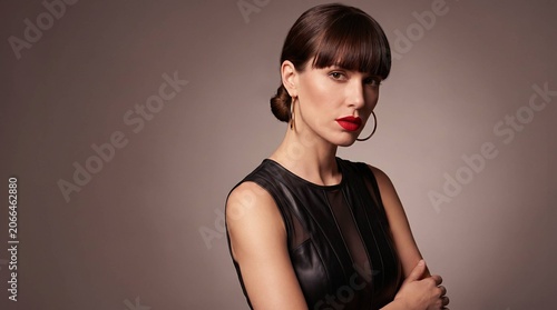 Striking Brunette Model with Blunt Bangs and Bold Red Lipstick in Studio Portrait