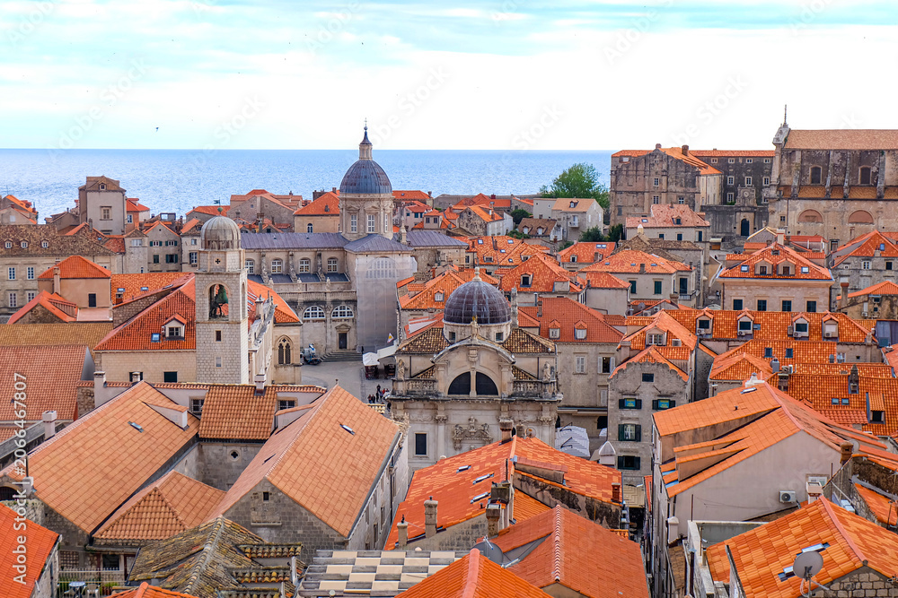 Obraz premium Aerial and above view of Dubrovnik old town, red and orange tile roof and walking the city wall around the old town on a sunset beautiful time, Croatia 