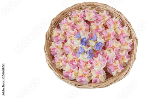 Handmade craft Thai festival decoration,Coins wrapped in floral ribbons on a basket against a white background.