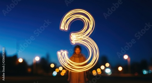Light Painting Number Three Created at Night with Bokeh Lights.