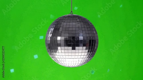 A shiny silver disco ball hangs against a vibrant green screen background