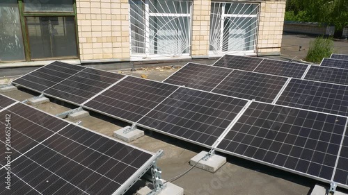 The Concept of Green Energy in an Urban Environment. Solar panels on the roofs of old apartment buildings. A rooftop solar power plant.