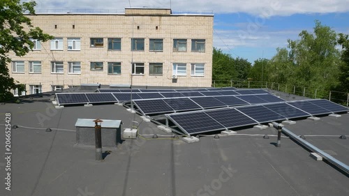 The Concept of Green Energy in an Urban Environment. Solar panels on the roofs of old apartment buildings. A rooftop solar power plant.