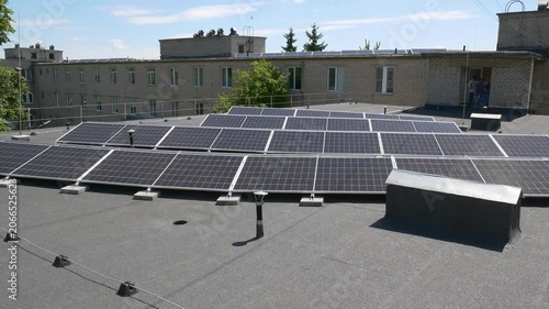 The Concept of Green Energy in an Urban Environment. Solar panels on the roofs of old apartment buildings. A rooftop solar power plant.