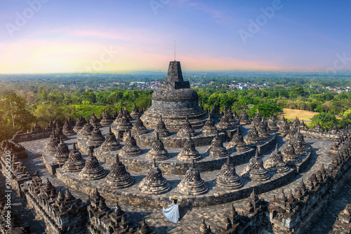 Tourist visiting in ancient largest Buddhist Borobudur Temple in Java Indonesia.