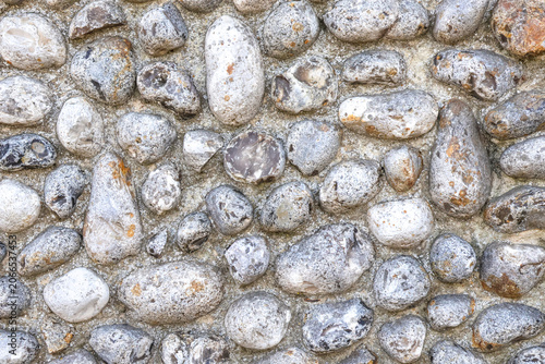 A Norfolk flint wall made of round stones in closeup