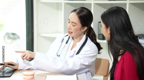 Professional dentist consulting with a patient in a modern dental clinic, explaining teeth restoration, prosthetic options, oral health care, treatment plans, and dental hygiene during a routine check