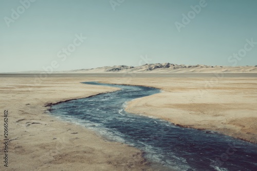 Serpentine River Winding Through Arid Desert Landscape Under Clear Sky.