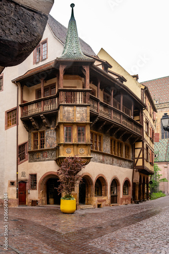 Photos Ornate carved balcony and timbered bays overlooking damp square, detailed woodwo