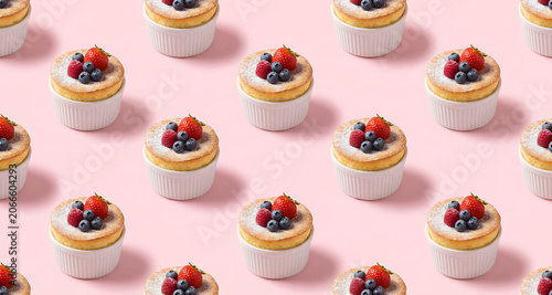 Pattern of Mini Berry Soufflés or Cheesecakes in White Ramekins on Pink Background