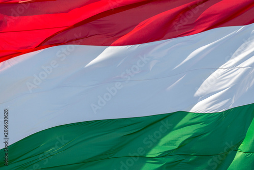 Hungarian flag waving in bright sunlight with vivid colors in a clear outdoor setting during the day