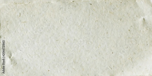 Natural off-white handmade paper background with visible cellulose fibers, uneven raw texture and subtle surface imperfections, empty vintage craft sheet with clean space for creative projects