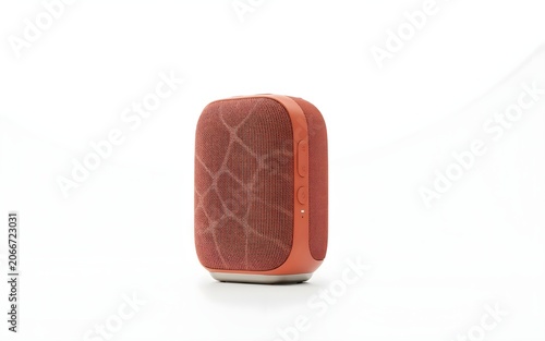 Modern terracotta orange portable speaker covered in textured fabric mesh isolated on a seamless studio backdrop