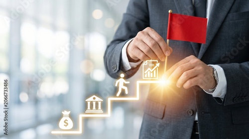 Businessman placing a red flag on a glowing step symbol representing business growth and financial planning milestones with business milestone planning strategy investment leadership