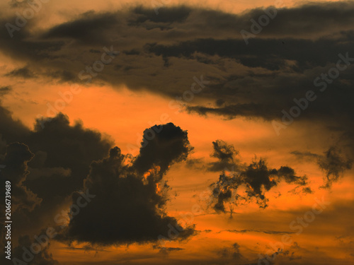 Fotografie Dark thick clouds that partially obscure the bright sun twilight rays sunlight penetrating through clouds stormy weather or afternoon skies