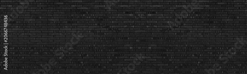 Black rough brick wall wide panoramic texture. Dark exterior brickwork backdrop wallpaper. Abstract gloomy grunge large long background