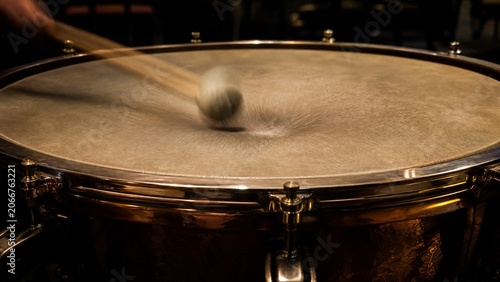 timpani. Timpani drumhead with blurred mallet impact and deep vibration. product launch decks, UI/UX mockups, designed for product launches and innovation pitches, clarifies data.
