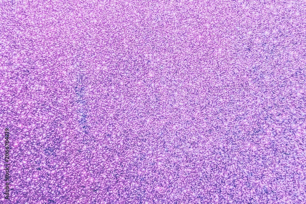Fototapeta premium Textured purple glitter background, with subtle sparkle effects