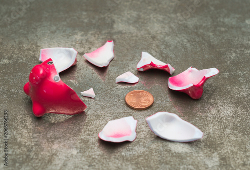 Red Smashed Piggy Bank with one cent