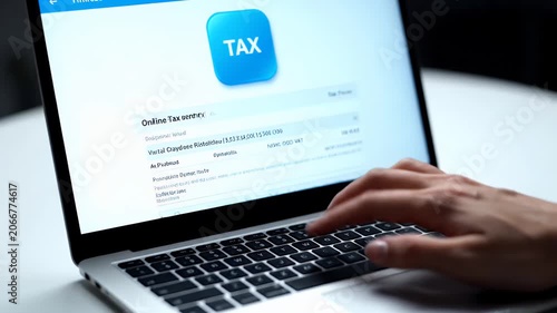 Fingers Type On Laptop Keyboard With Tax Application On White Screen In Focus Against A Clean White Background