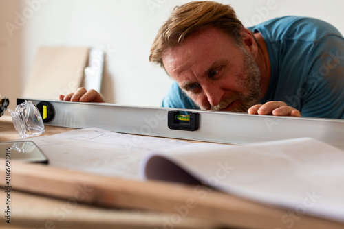 Photography Focused carpenter measuring wood precisely