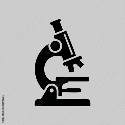 Black silhouette icon of a scientific microscope on a gray background
