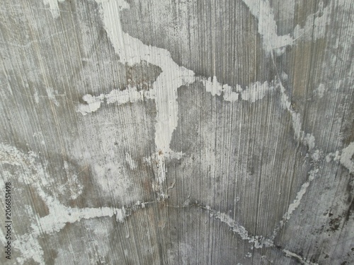 Tableau sur toile Close-up of aged wall surface with peeling paint, gray patches, white streaks, and textured weathered patterns showing natural decay