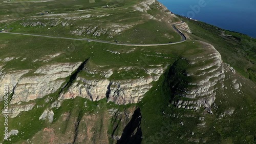 Aerial views of cliffs in Llandudno with the ocean in the background. Roads wind along the cliffs, showcasing nature and scenery in the area