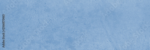 Solid light blue texture with speckled mottled matte finish is suitable for backgrounds, design projects, and artistic creations. Smooth painterly azure backdrop.