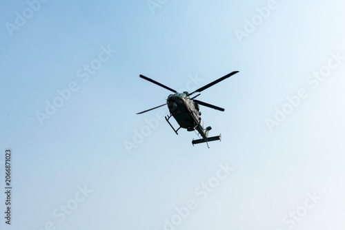 Military helicopter air attack on isolated blue sky