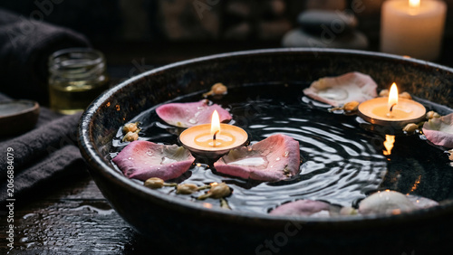 Floating Candles and Flower Petals in Water, Dark Spa Mood with Soft Reflections