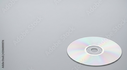 Reflective CD or DVD Disc on Light Grey Background with Copy Space, Concept of Digital Data Storage, Media, and Software Backup