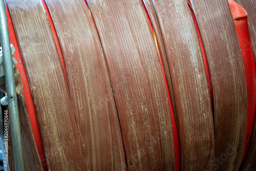 Bilde på lerret Dirty Fire Hose Close-Up Showing Wear and Operational Use, Close-up of a used firefighting hose showing dirt, wear marks and textured surface after operational use