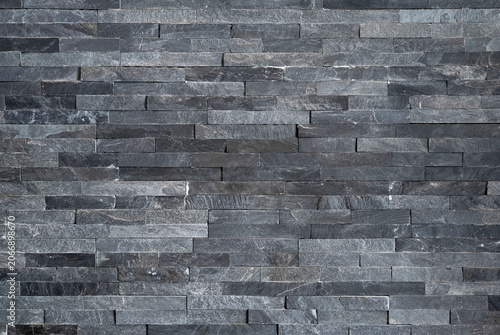 Foto Background of textured natural stone tiles in grey color, modern dark gray slate