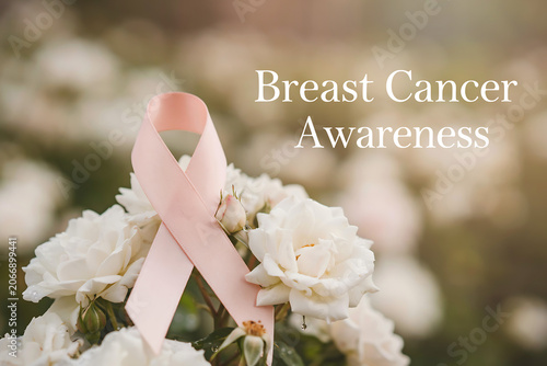 A delicate pink awareness ribbon is beautifully arranged with fresh white roses and rosebuds while the powerful text 'Breast Cancer Awareness' is overlaid on the image