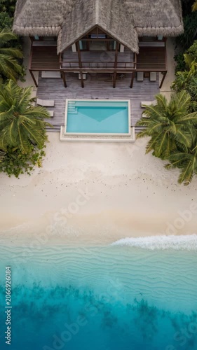 Aerial view of a luxury villa with private pool on a tropical beach