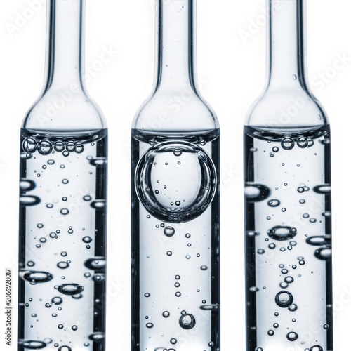 Three glass ampoules filled with clear liquid and bubbles.
